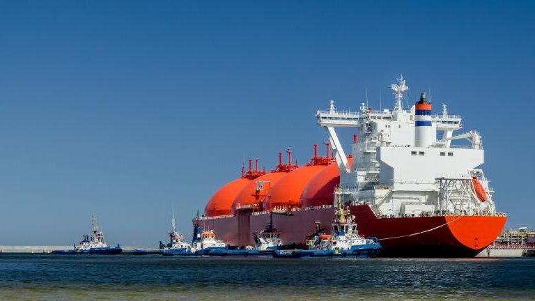 RED LNG TANKER AND SWARM OF TUGBOATS - A giant ship moored to the gas terminal in Swinoujscie shutterstock_1421288093.jpg